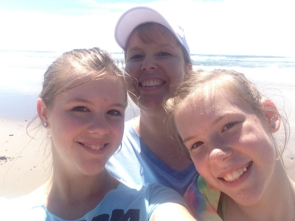 Julie and her two daughters at the coast.