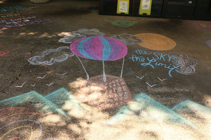 Chalk drawing of hot air balloon with "the sky's the limit" text.