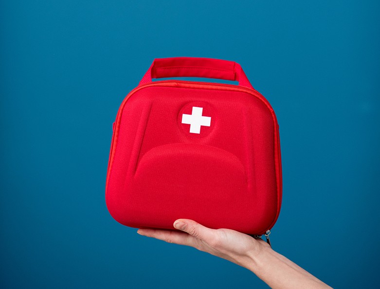 First aid kit on the blue background