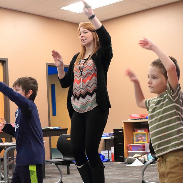 Sarah Long dances with elementary kids to get the wiggles out at Quest Academy in Longview.